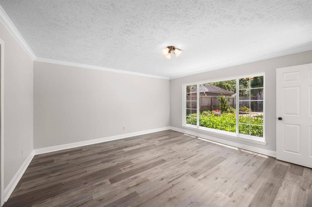 Primary bedroom with large window and view of the pool!