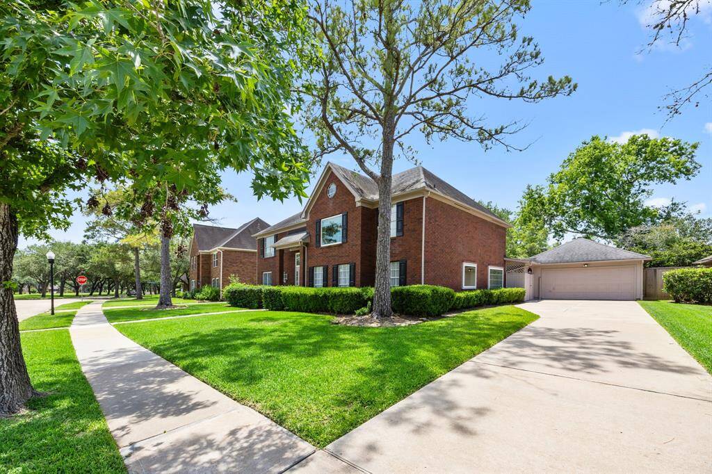 Long driveway leading to detached garage.