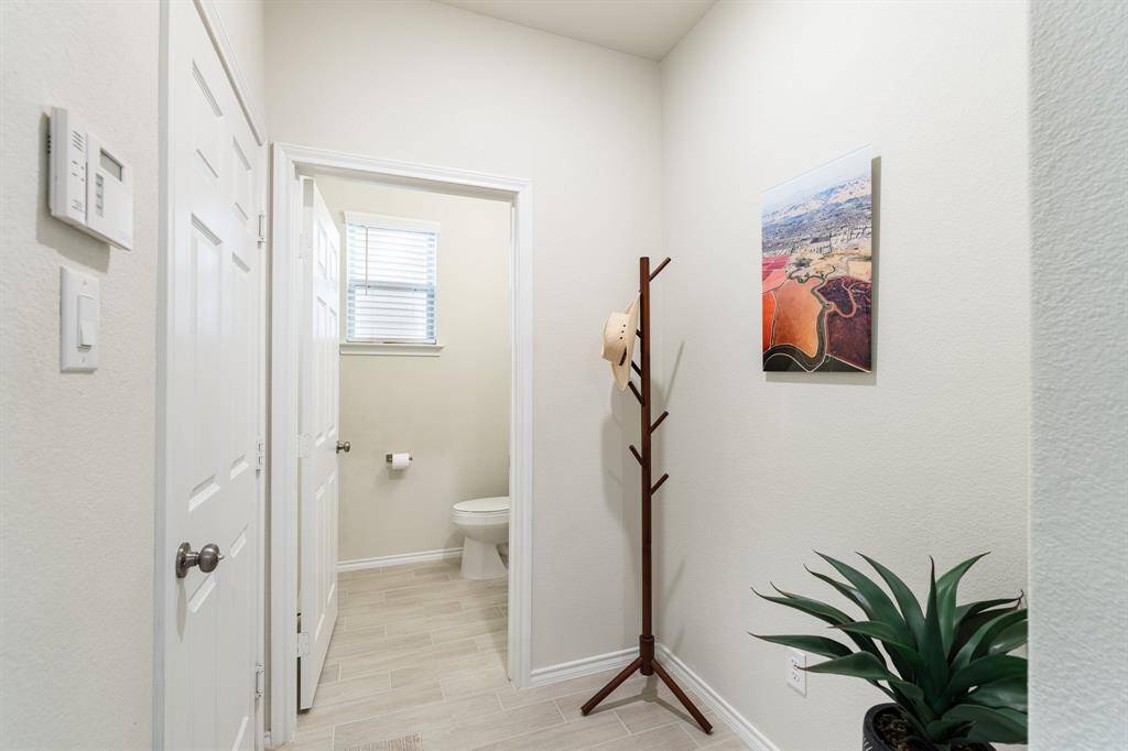 The home's attached, two car garage opens to a mudroom area.