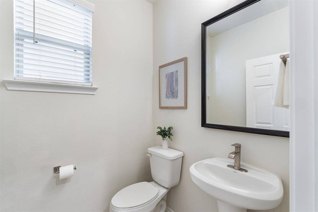 First floor half bath with pedestal sink.