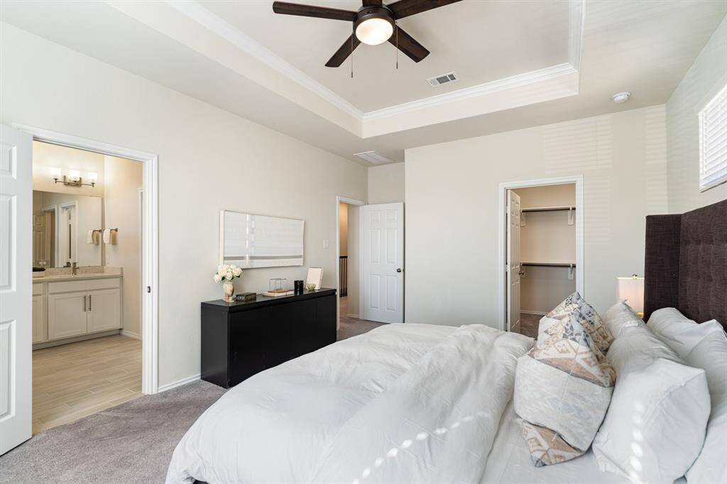 This luxurious and private bedroom is designed for relaxation and comfort, and features an en-suite bathroom and dual walk-in closets.