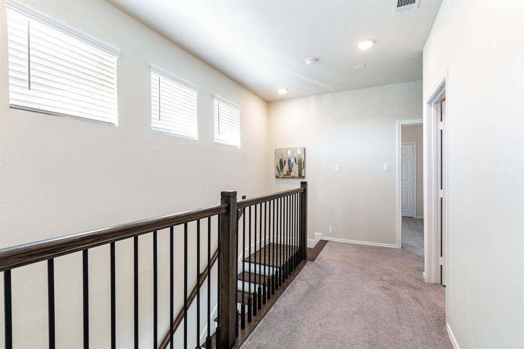 Beautiful and upgraded stair railing with rich wood and black iron detail.