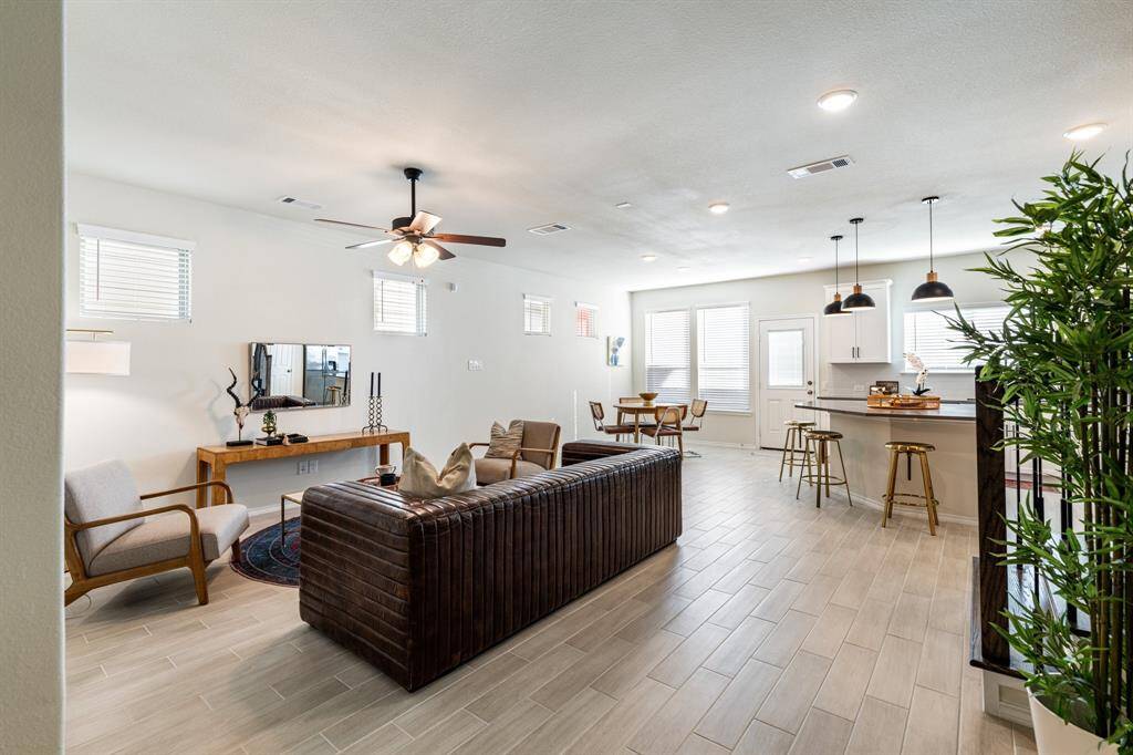 Welcome home! Here's the view that greets you from the front door. Calming color palette and durable light wood tile are both soothing and sturdy.