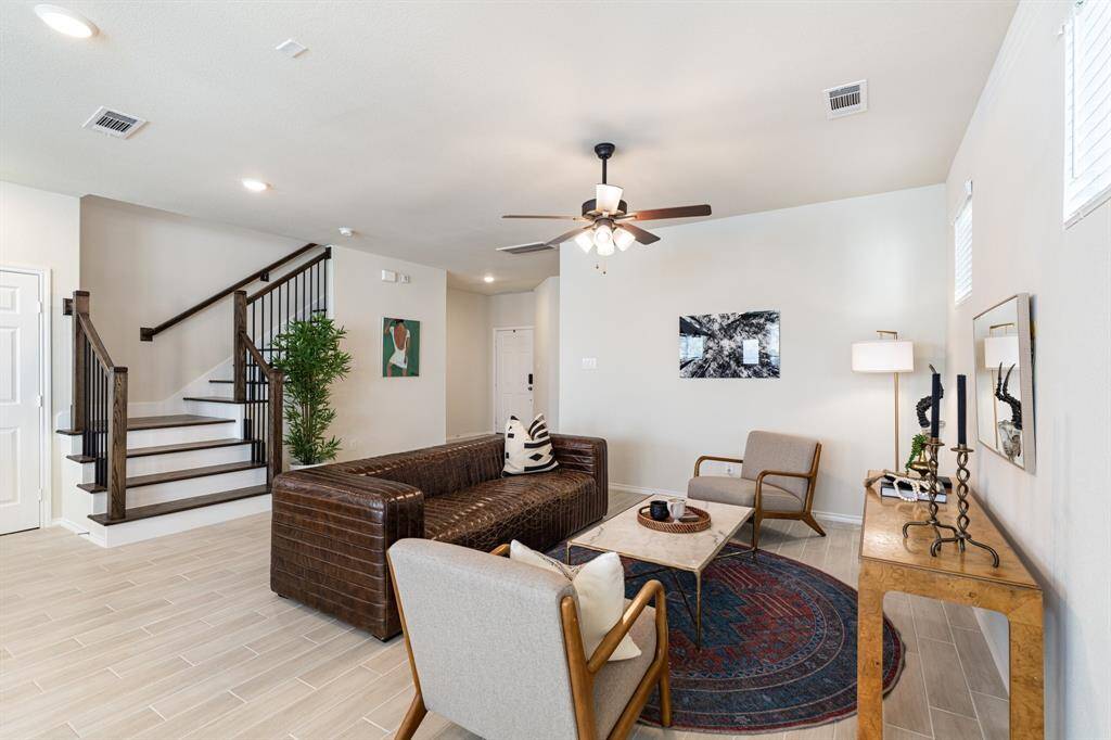 Hardwood stair treads and iron balusters add to the modern and sophisticated design of this home. This living room was made for you to kick your feet up and de-stress.