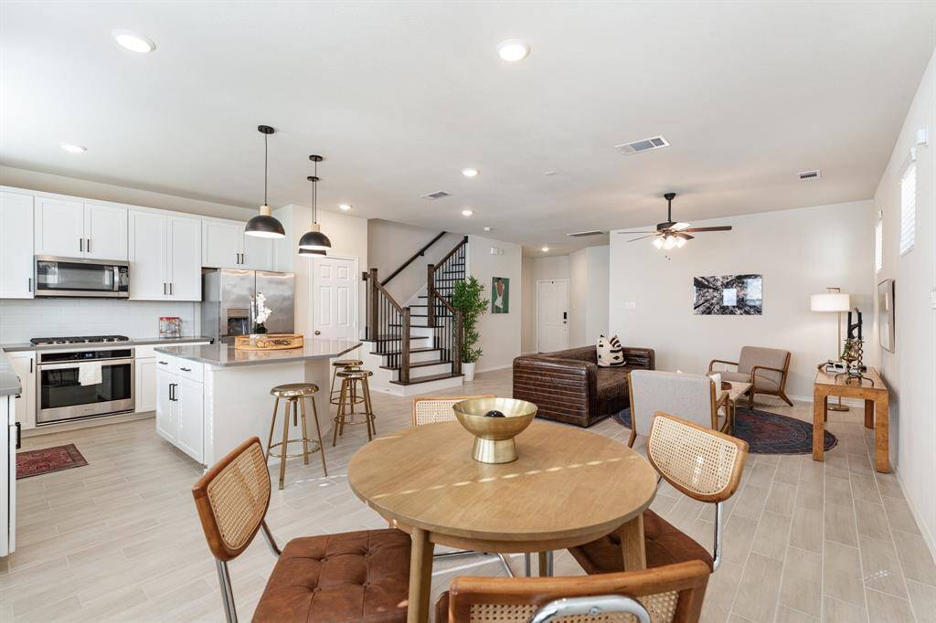 This first floor, open concept living area is complete with designated dining and living room areas, large chef's kitchen with island seating, and a pretty powder room. Enjoy the perfect combination of comfort and convenience!