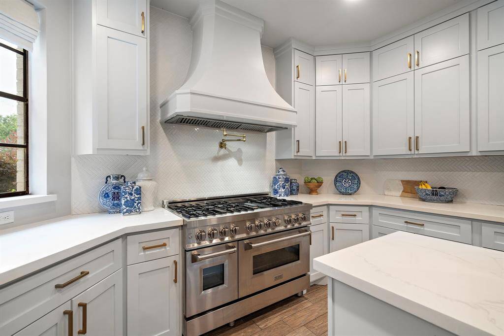 A chef’s dream awaits with a high-end stove as the centerpiece.