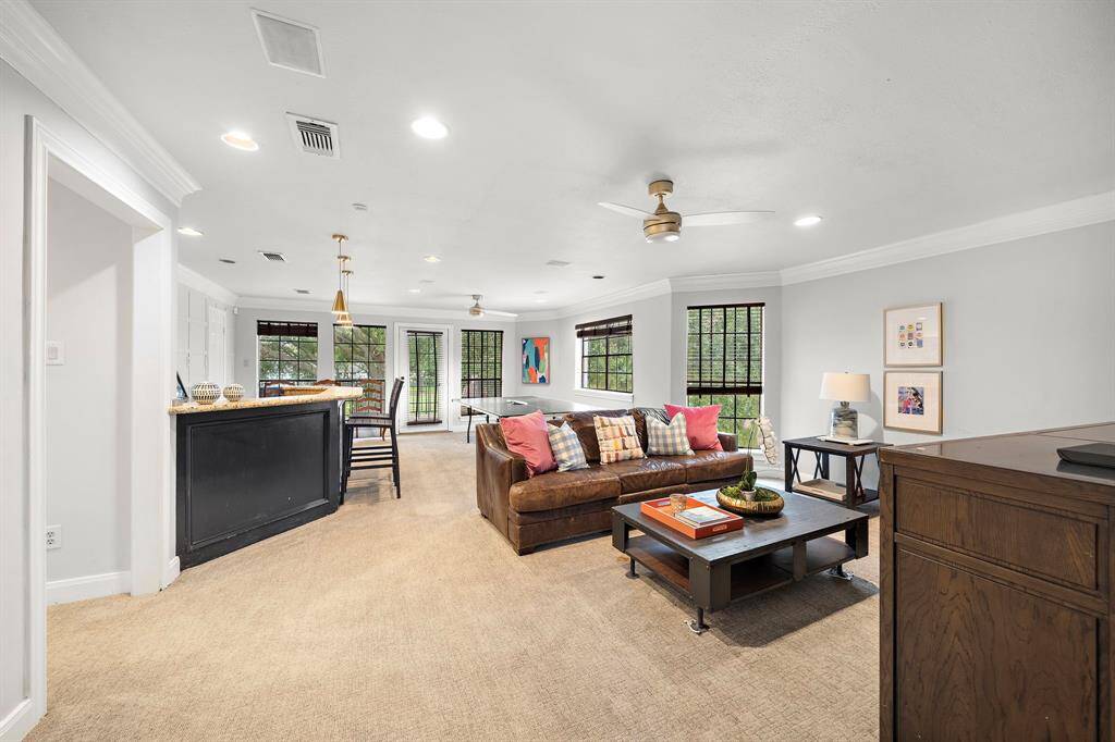Upstairs, discover a large game room with a built-in bar and access to a private balcony, perfect for taking in golf course views.