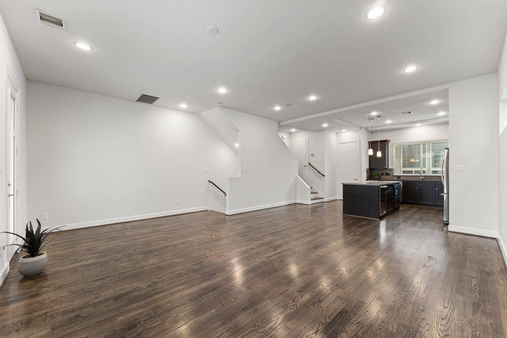 This stunning open-concept space offers a seamless flow from the living area to the modern kitchen, perfect for entertaining and everyday living.