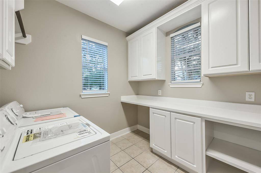 Large laundry room located downstairs off the kitchen