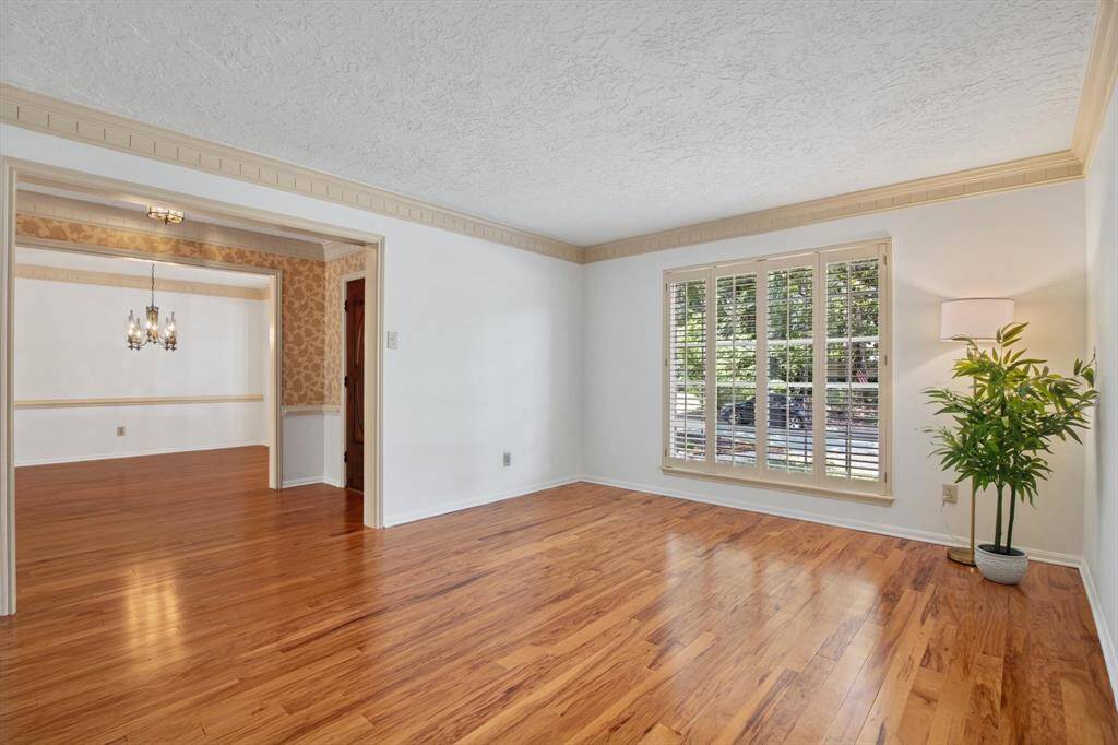 Formal living room with the same genuine hardwood - big windows , crown molding - custom build details everywhere
