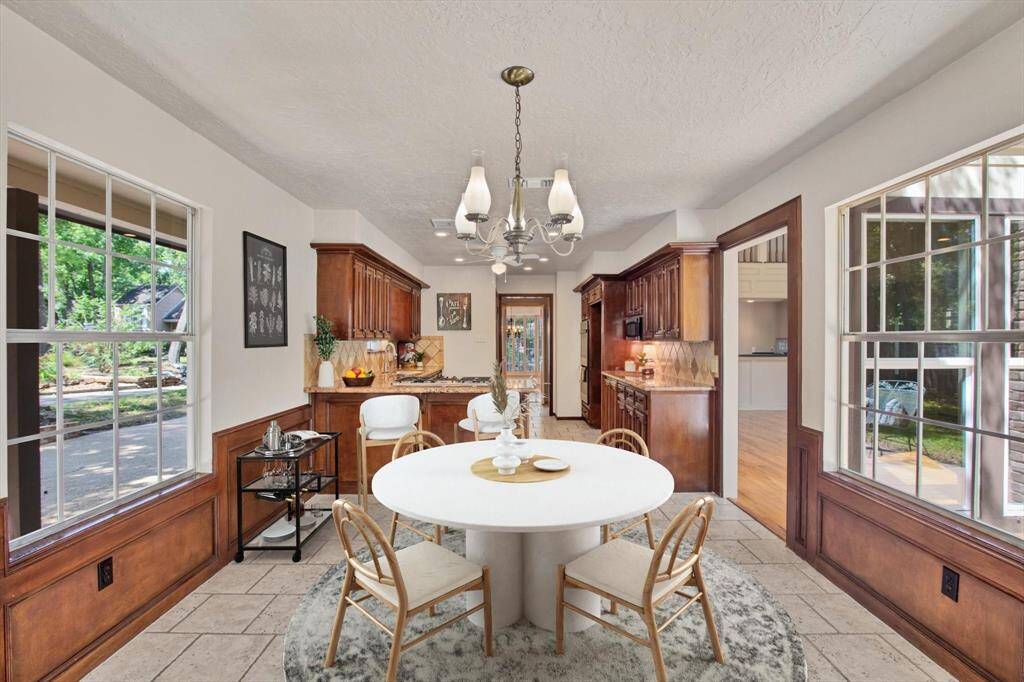 Stone tile backsplash, bar seating and a nice sized breakfast table area surrounded by windows and privacy at the same time