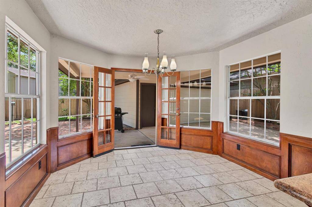 Between the kitchen and the dining room - straight through - on the left there is a utility/mudroom with it's own exterior door and covered walkway to make it easy bringing things in from your car