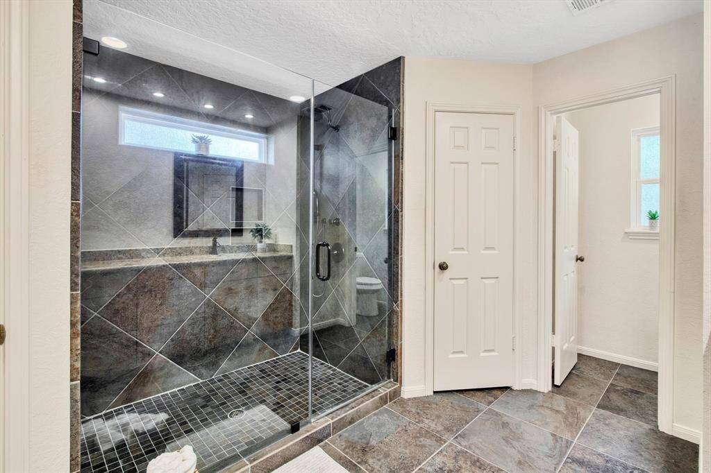 Master bath with dual sinks, his and hers walk-in closets, linen closet and remodeled cabinets, counters, shower and floors in 2013