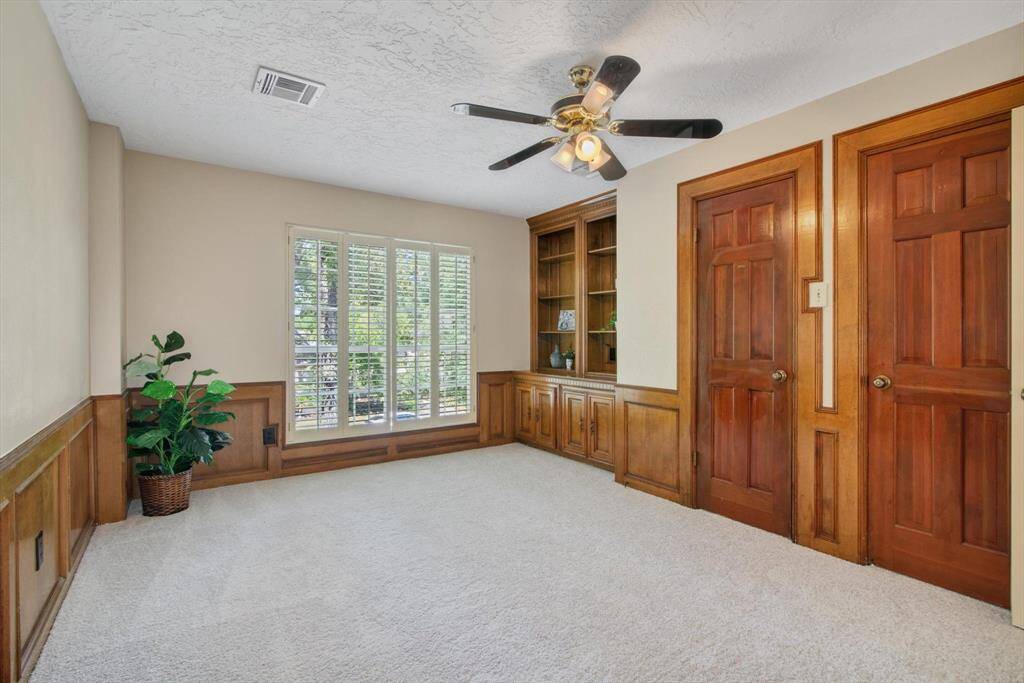 This is the gameroom which can easily be used as a 5th bedroom, office, or whatever suits your needs.  Those doors are 2 nice sized closets.  There are plenty of closets in the entire home - bathrooms with linen closets, large bedroom closets, coat closets - it's easy to live in this home with a place for everythin