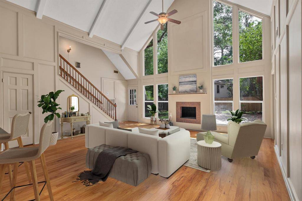Known as the "Great room" with cathedral ceilings, floor to ceiling windows, statement making modern fireplace, and those beautiful genuine hardwood floors.  Fresh interior paint - it's move-in ready.