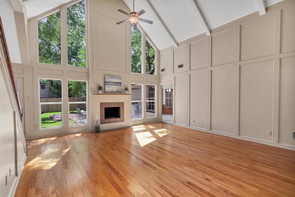 Back right in this photo is the kitchen with French doors opening to the backyard.  Floors are Capella Pecan Classic hardwood. Such a family friendly and relaxing home!