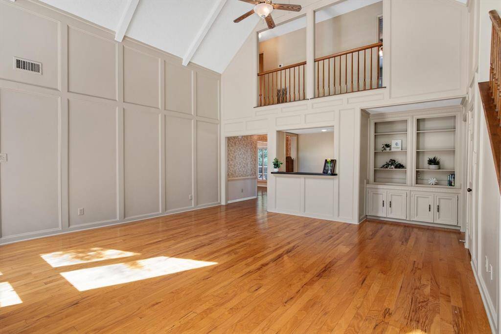 Here you can see the built in shelves and cabinets along with the door to the master bedroom is  in the back right in this photo