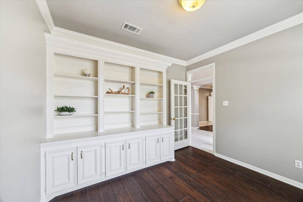 Look at this charming office tucked away for privacy with built in cabintry.