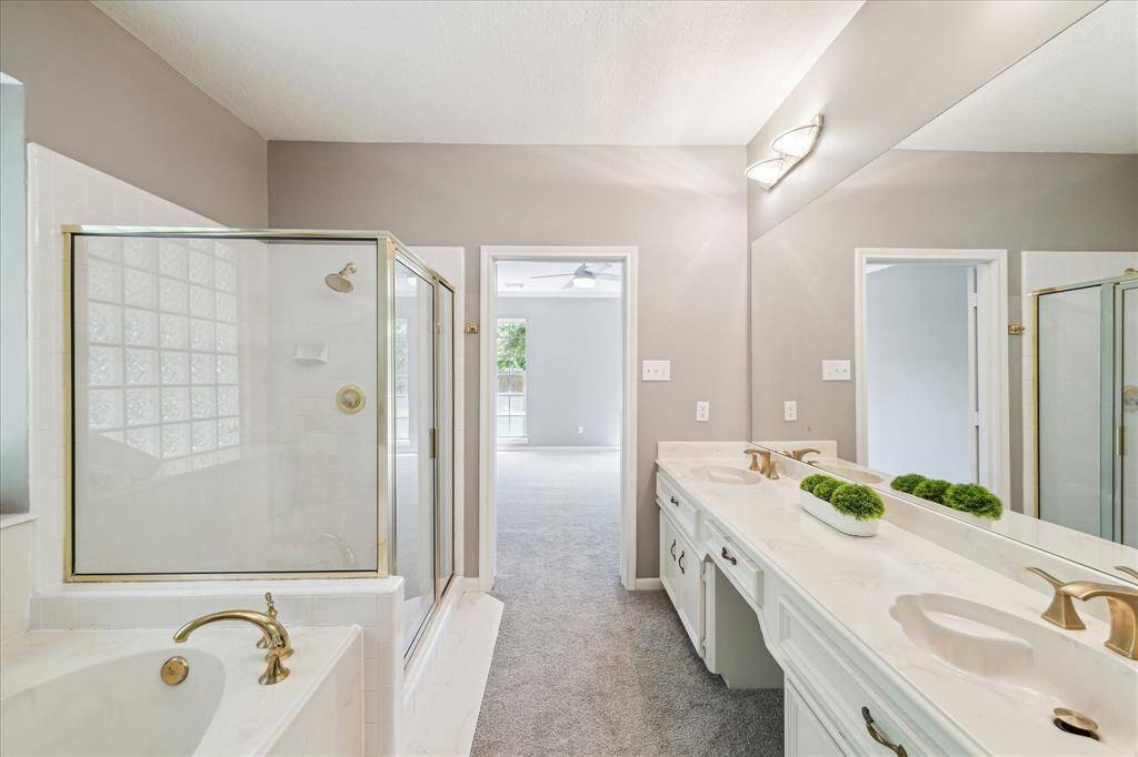 The Primary bath has his/he sinks, large tub and expansive shower.