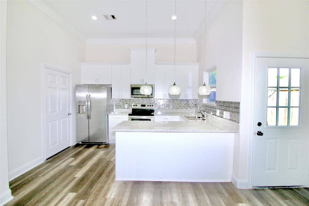 Kitchen has all stainless steal appliances including refrigerator