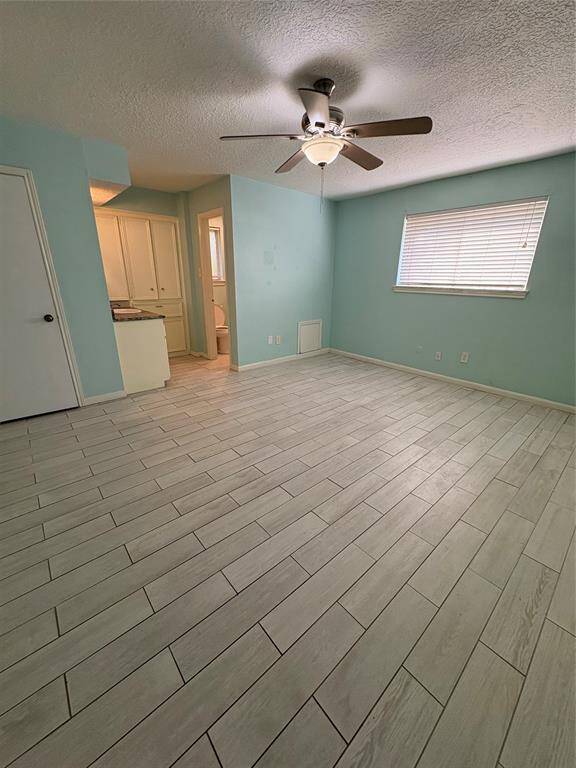 Primary bedroom with a lot of natural lighting, new fans and a powder area.