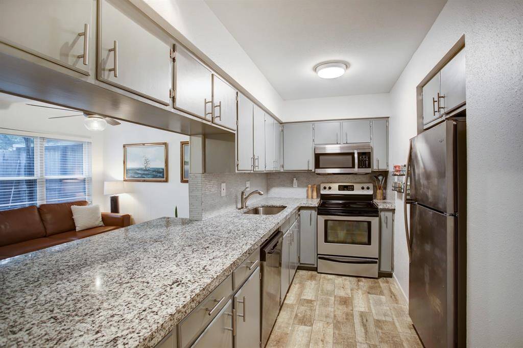 View of spacious kitchen with abundance of storage.
