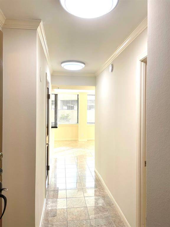Entry hall from front door with secondary bedroom on the right and the hall bath on the left. New light fixtures have been installed.