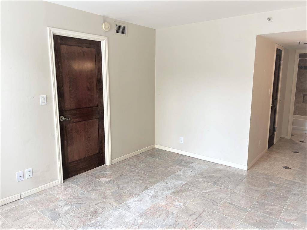 Primary bedroom with entry door to the left of center of the photo