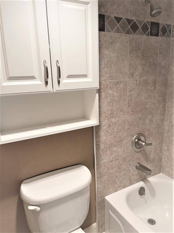 Toilet with cabinet above