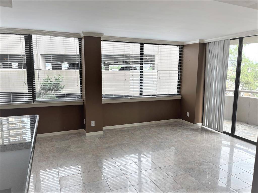 (Walls have been repainted a light neutral color. See in next 3 photos.) Living area with a wall of windows bringing in so much light