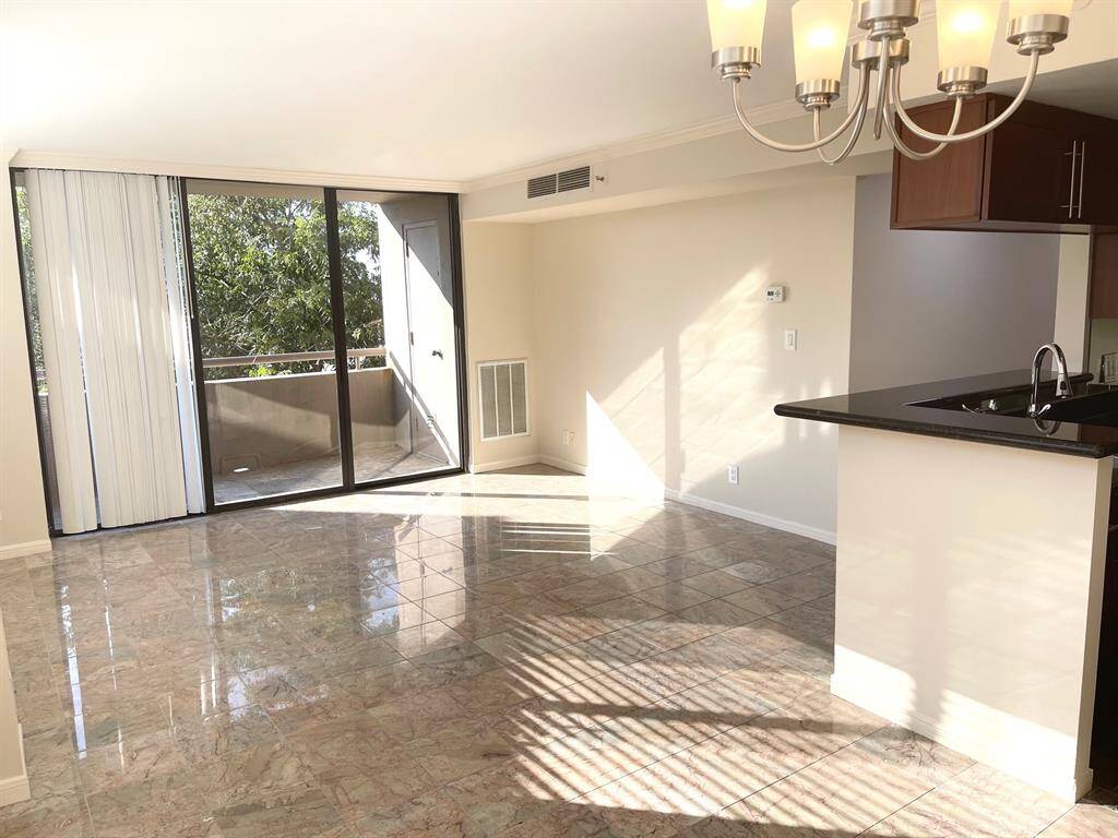 Living room from the dining area. Sliding glass doors lead to the balcony