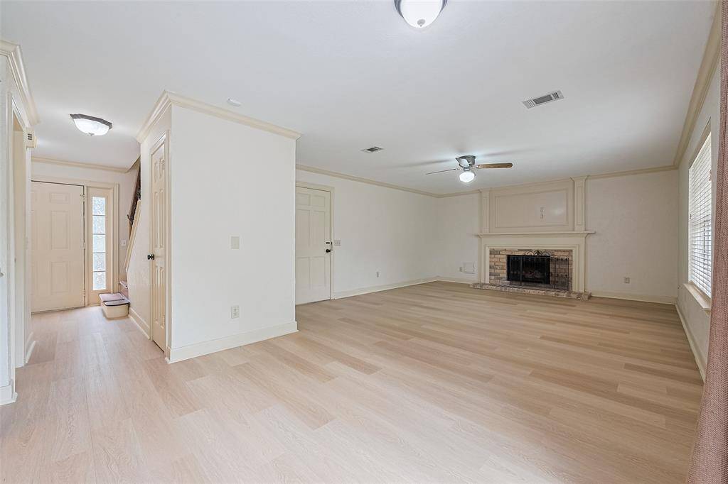 Formal living with fireplace and ceiling fan