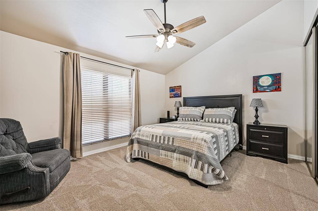 Comfortable primary bedroom with fresh carpet and a calm, neutral color palette.