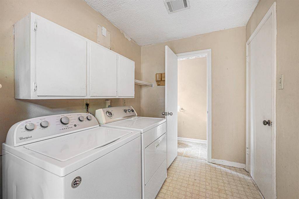 Off the kitchen is the laundry room and half bathroom with access to the backyard.