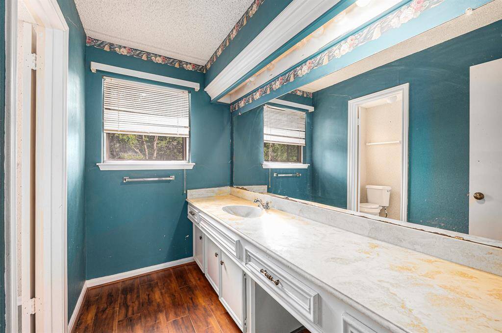 Primary bathroom offers vanity seating and a glass-standing shower.