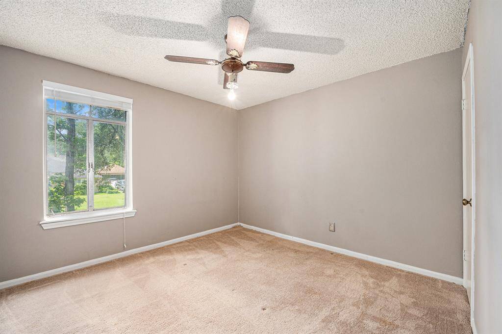 Secondary bedroom with a walk-in closet and overlooks the front yard.
