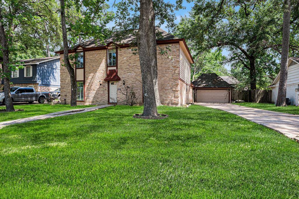 This home offers ample driveway space leading up to the detached two-car garage.