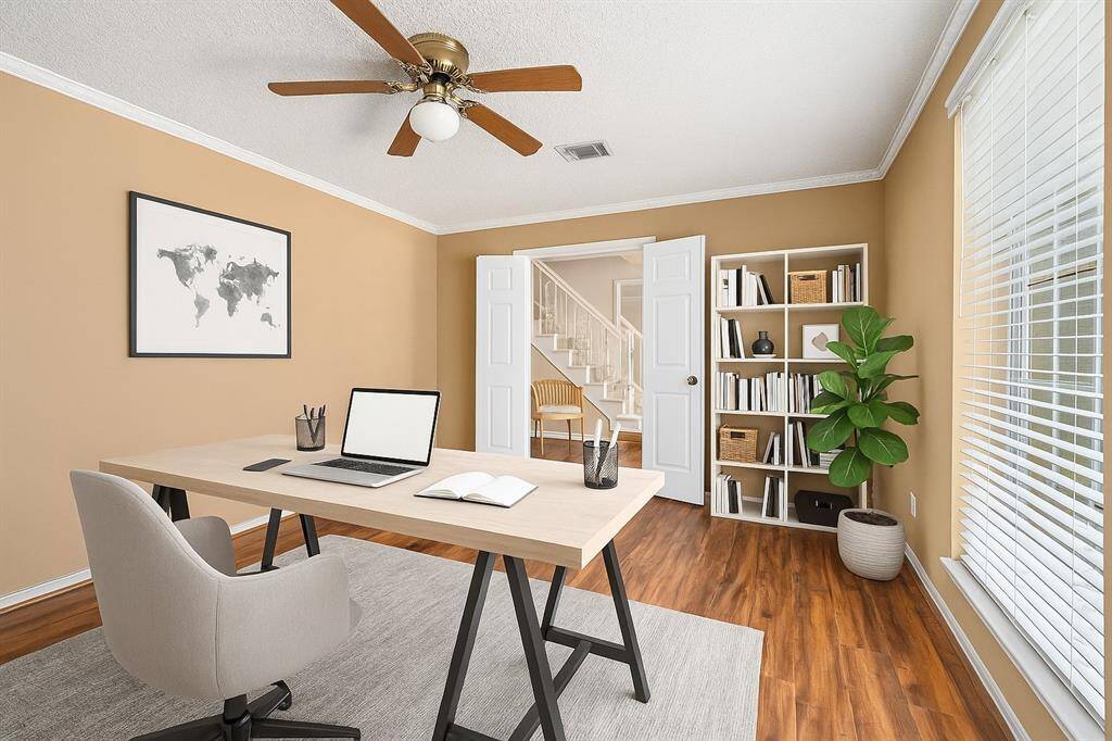Spacious home office that overlooks the front yard. (Virtually Staged)
