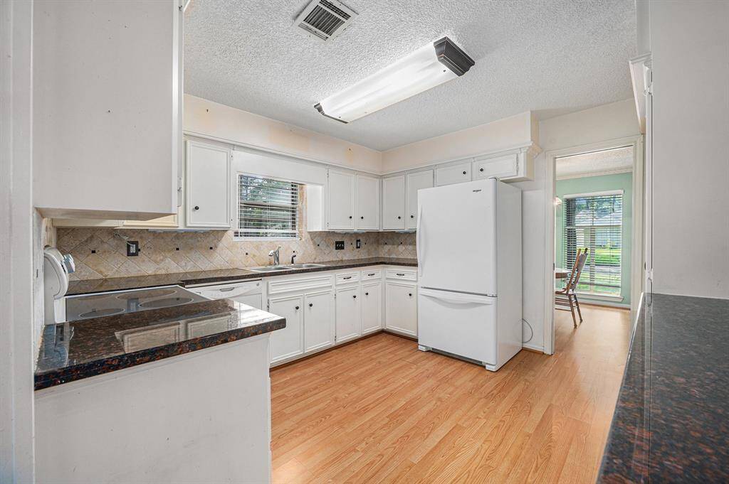 This kitchen showcases tons of cabinet and granite countertop space!
