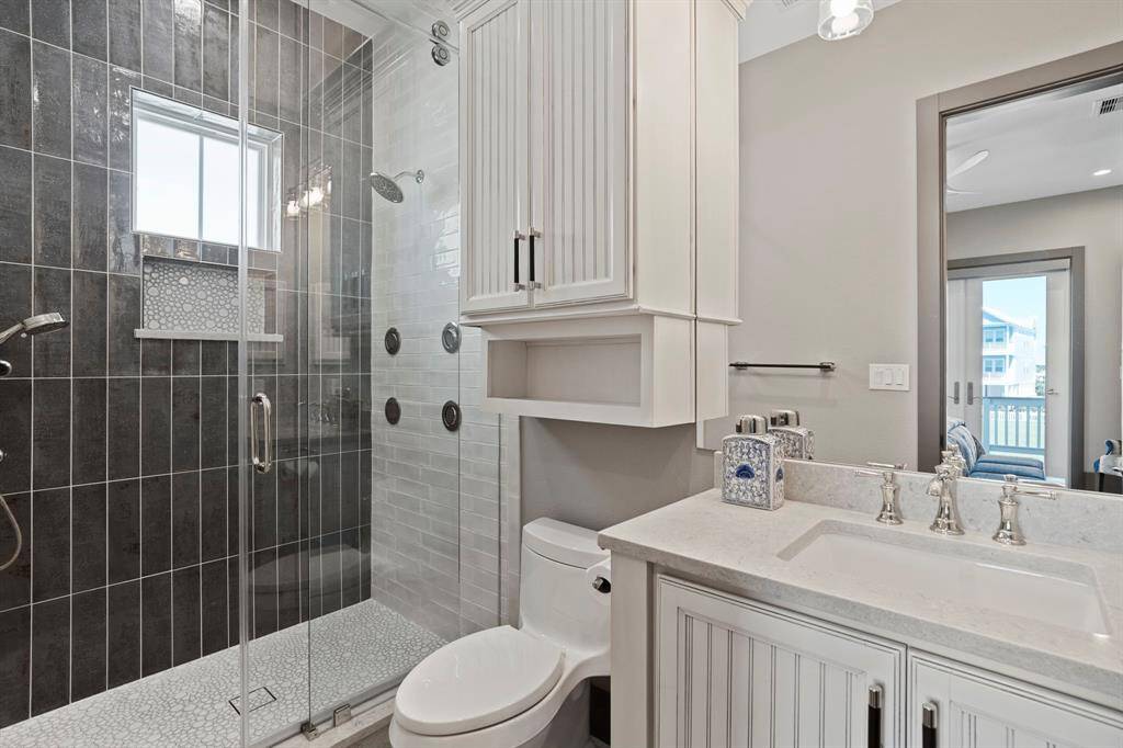 Shared secondary bath with walk-in shower.