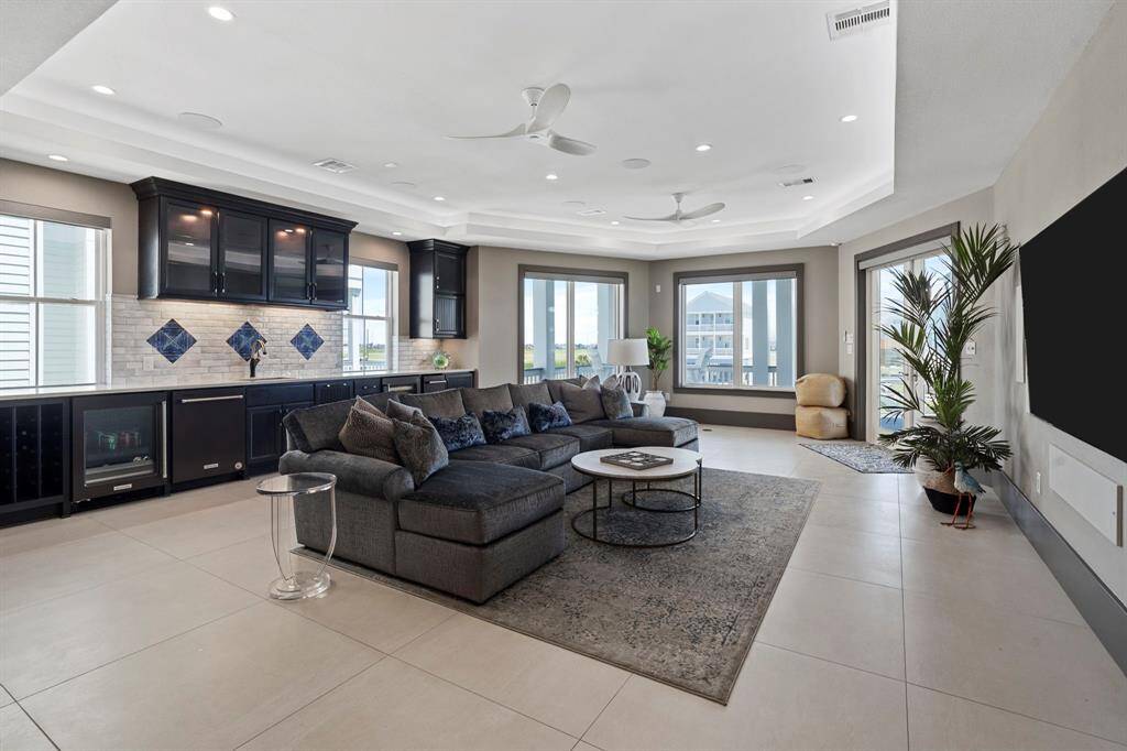 Spacious game room/living room with wet bar.