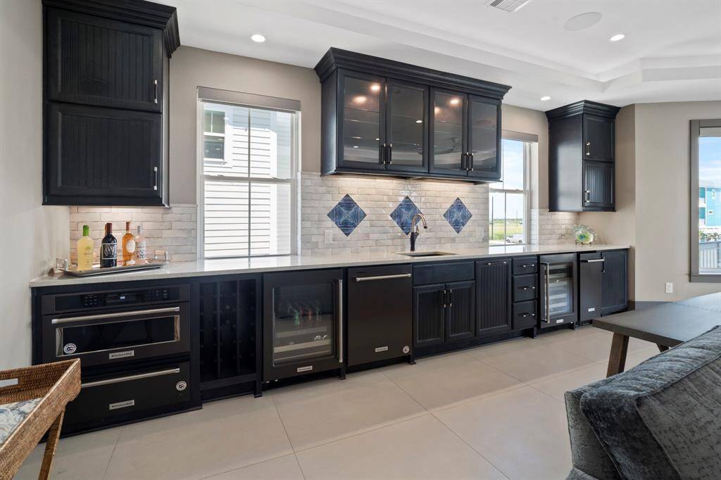 Beverage and wine fridge, microwave, warming drawer, dishwasher, ice machine and plenty of cabinet space for storage. Great hang out space for cheering on your favorite sports teams year round.