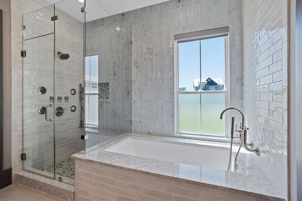 Relax and unwind in this spa-like primary bath. Neutral colors and elegant details are calm and soothing.