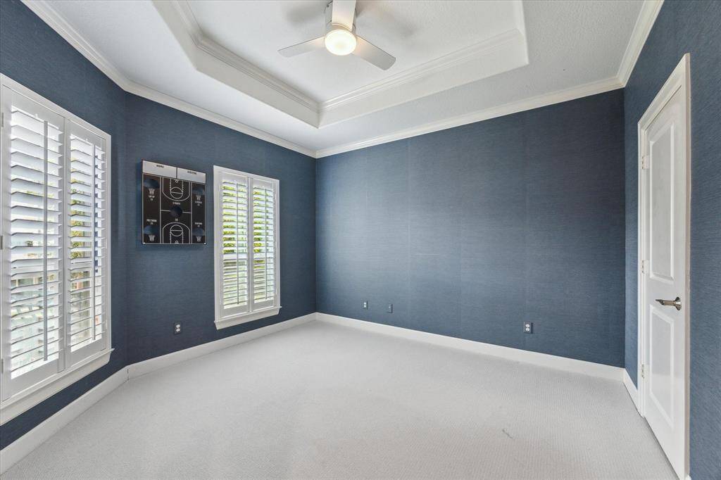 Secondary bedroom with grass cloth wallpaper.