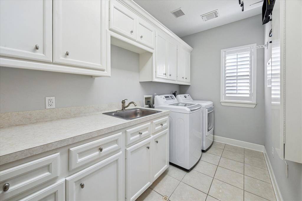 Spacious laundry room with sink.