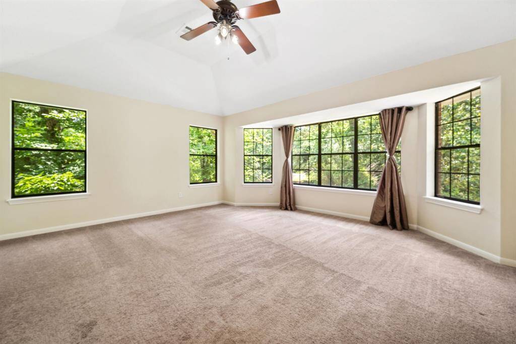 The primary bedroom features sweeping panoramic windows that create a bright and airy retreat.