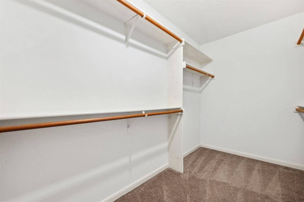 The primary suite also includes a walk-in closet with built-in shelving.