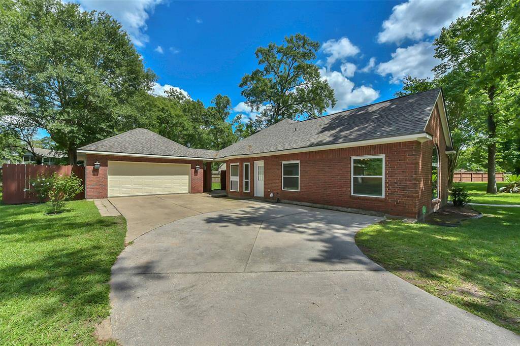 T home features a spacious driveway leading to a two-car detached garage. It provides ample parking space for mulitple family members.