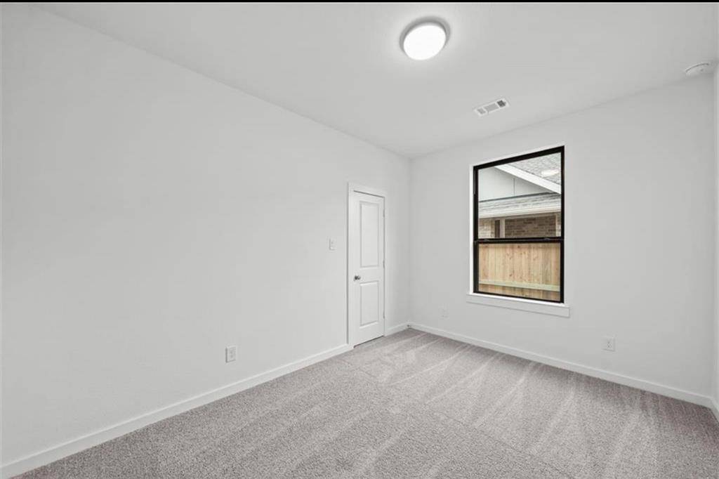 Secondary bedroom with walk in closet.