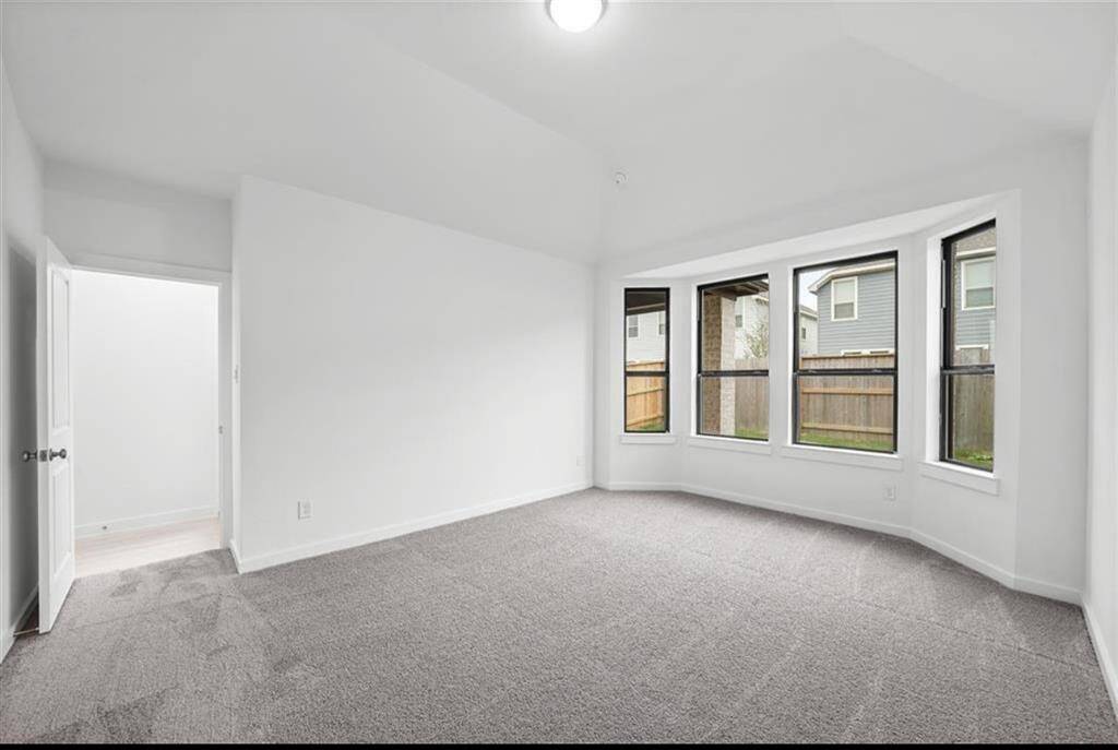 Large primary bedroom with bay window.